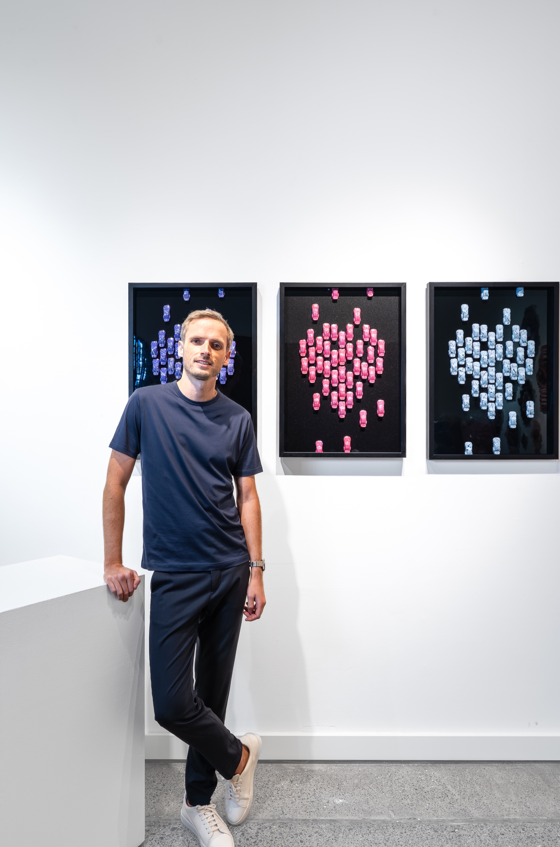 The artist in front of his works